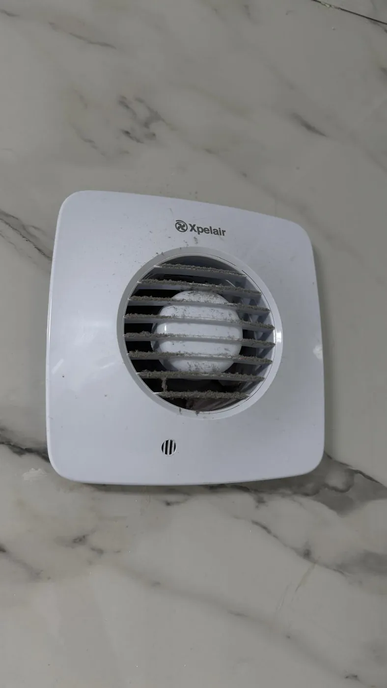 Bathroom extractor fan clogged with dust before cleaning